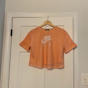 This is a coral colored shirt with a mesh shirt that connects to it.
